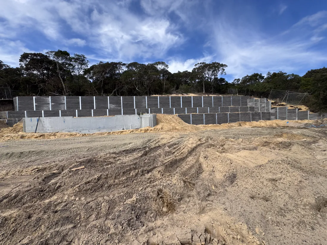 Multi-tier concrete sleeper retaining walls on a civil earthworks site, built by Align Excavation Group