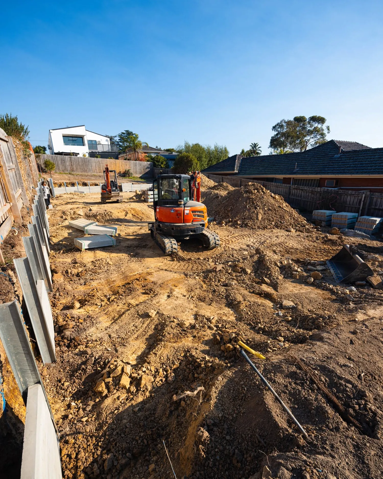 Two Align excavators cutting a block with sleepers and posts staged